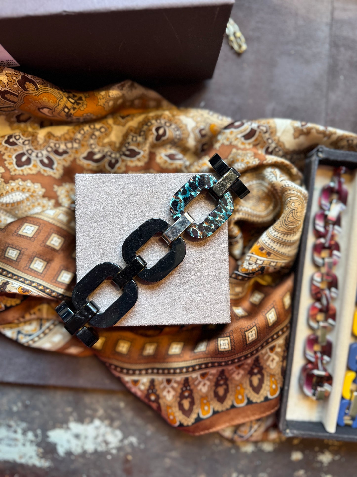 Black and silver chain bracelet with patterned link in blue tortoise shell style.