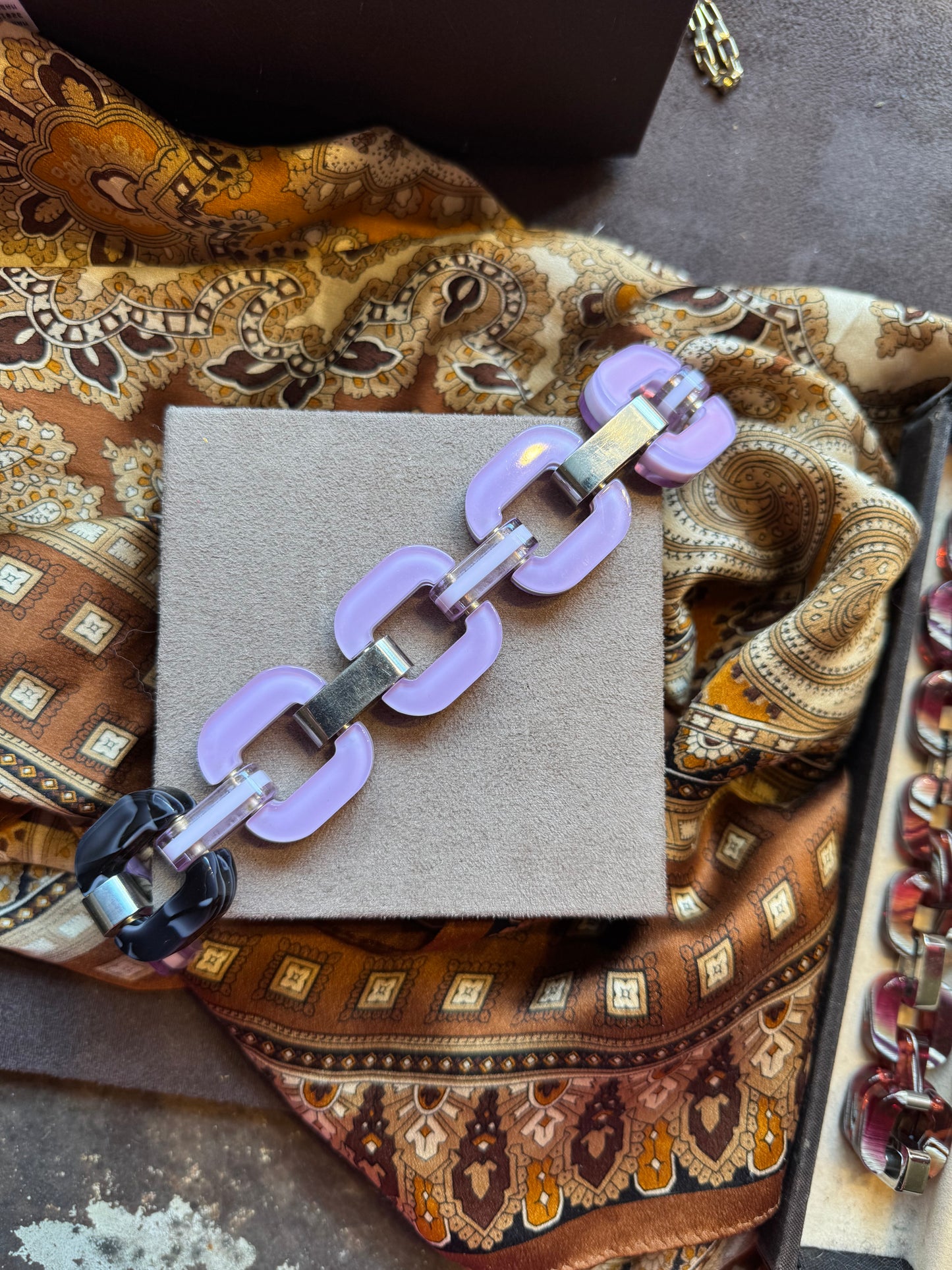 Purple chain bracelet with patterned link in a tortoise shell style.