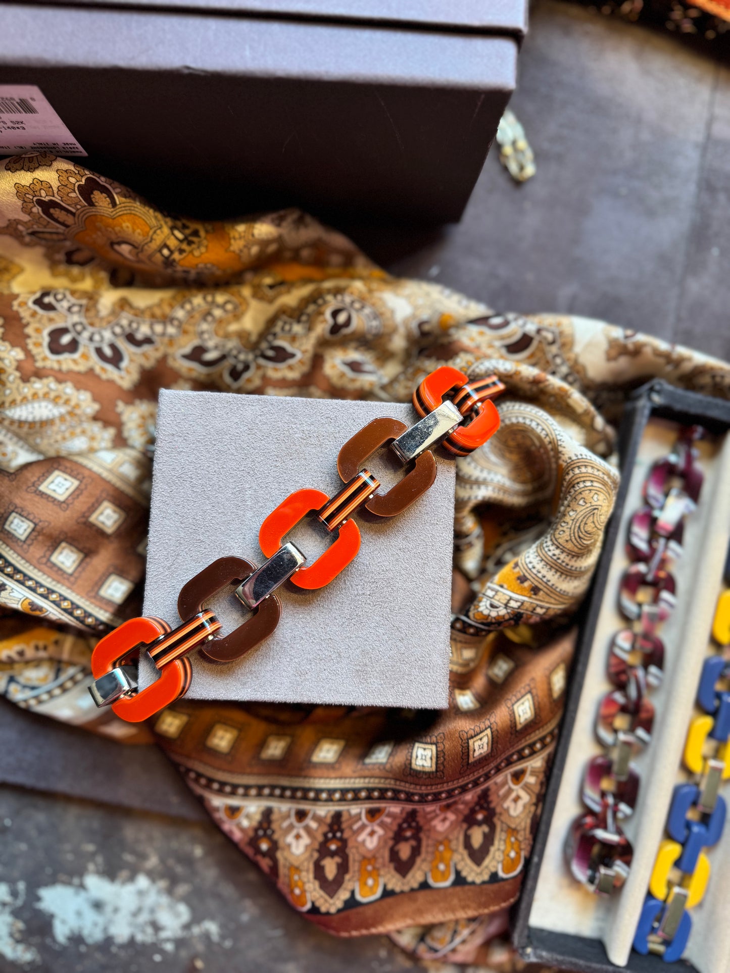 Bracelet with orange and brown links.