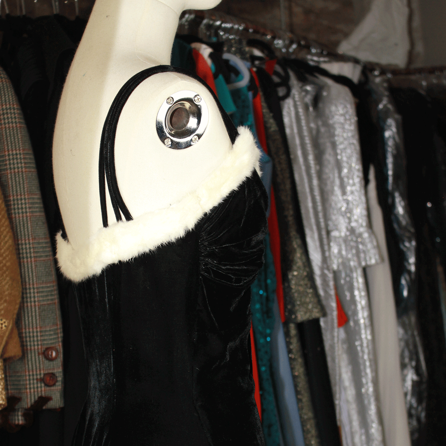 Vintage 1930s black velvet evening dress with white fur detailing.